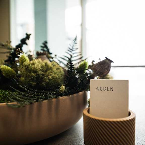 a plant on a table with a sign that says