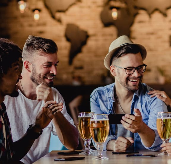 a group of people sitting at a table with drinks