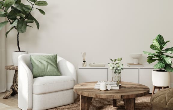 a living room with a white chair and a wooden coffee table