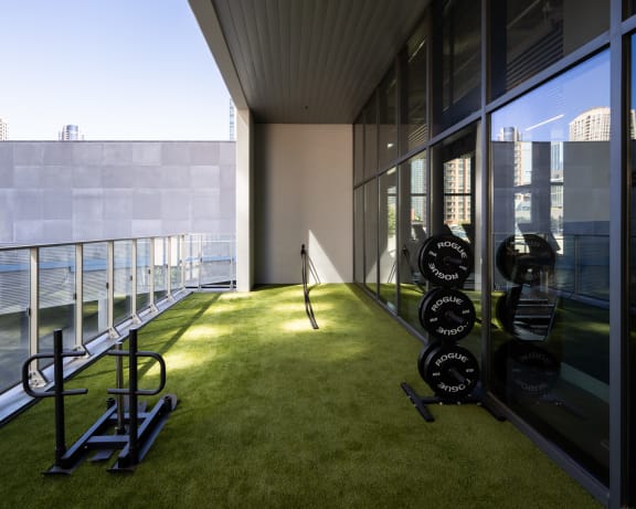 a room with an indoor grassy area and a view of the water
