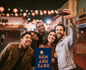 Group of Friends Taking Selfie Outside near Colorful Streamer Lights