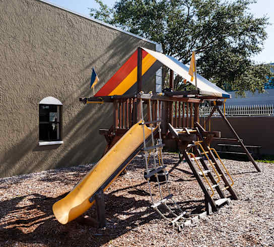 a playground with a swing set and a slide
