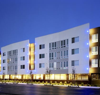 a large white building with a street in front of it
