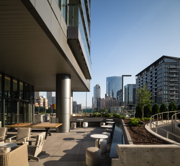 a large terrace with tables and chairs and a view of the city