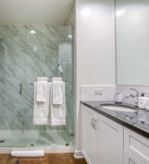 Bathroom with sink and shower at Grand Central Market Apartments, California, 90013