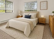 Thumbnail 2 of 8 - A bedroom with a large bed, nightstands, and a framed picture on the wall.