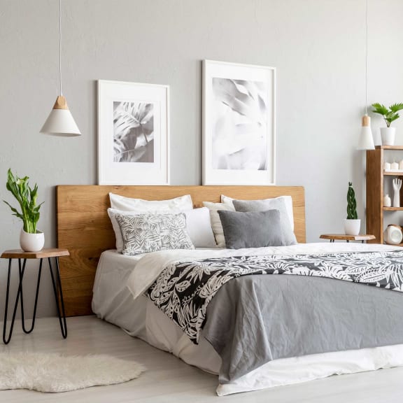a bedroom with a bed and pictures on the wall