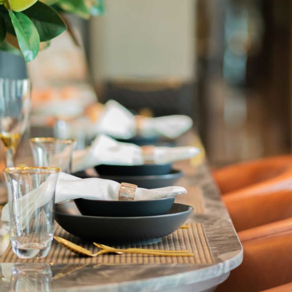 a wooden table with plates and glasses on it