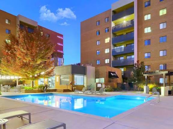 A swimming pool in a courtyard surrounded by buildings.