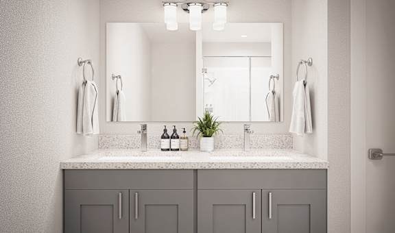 A bathroom with a large mirror above a double sink vanity.
