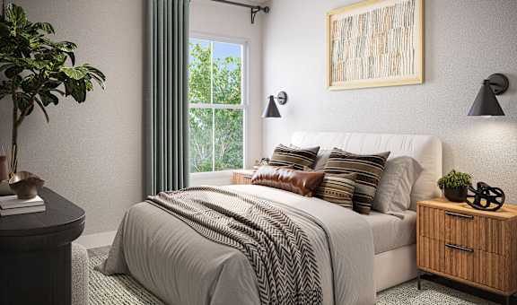 A bedroom with a large bed and a ceiling fan.