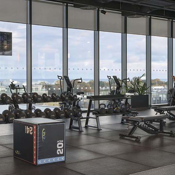 A gym with a view of the ocean.