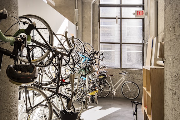 A bike rack with many bicycles parked.