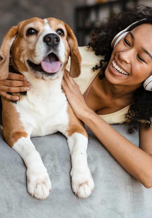 woman lying on the bed with her dog and listening to music free photo at The Commons at Rivertown, Grandville, Michigan