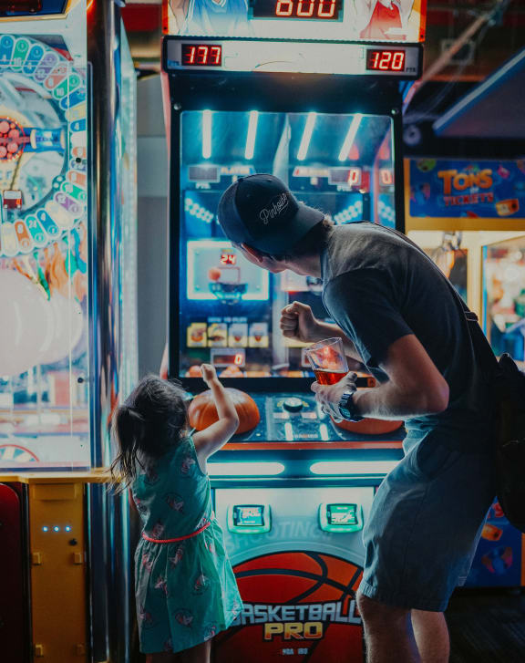 a man and a little girl playing a video game