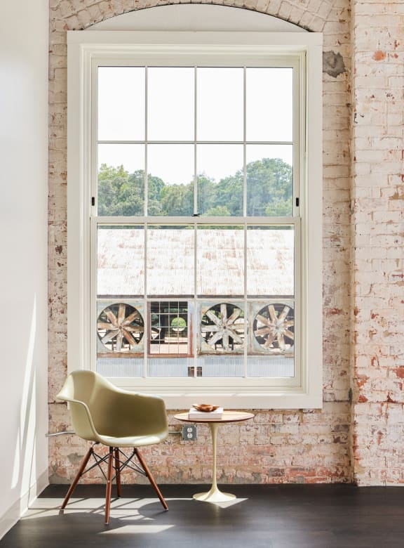 a large window with a chair and a table in front of it at The Mill at Prattville, Alabama