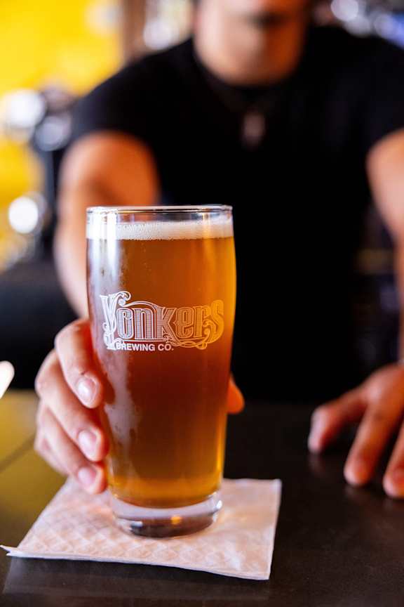 a man holding a glass of beer