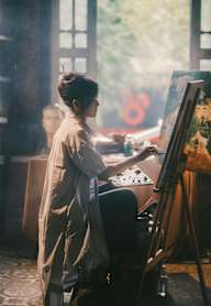 A woman is painting a picture in a studio.at Haven, British Columbia