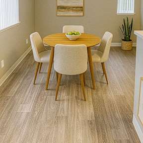 A dining room with a wooden table and chairs.