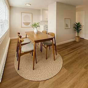 A room with a sliding glass door and a wooden floor.