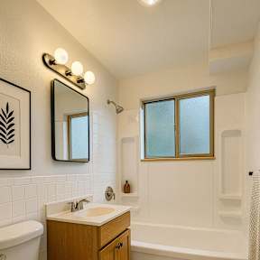 A white toilet sits next to a sink in a bathroom.