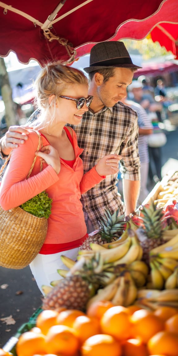 Young Couple at Farmers Market Shopping Together