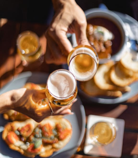 a group of people drinking beer and eating food