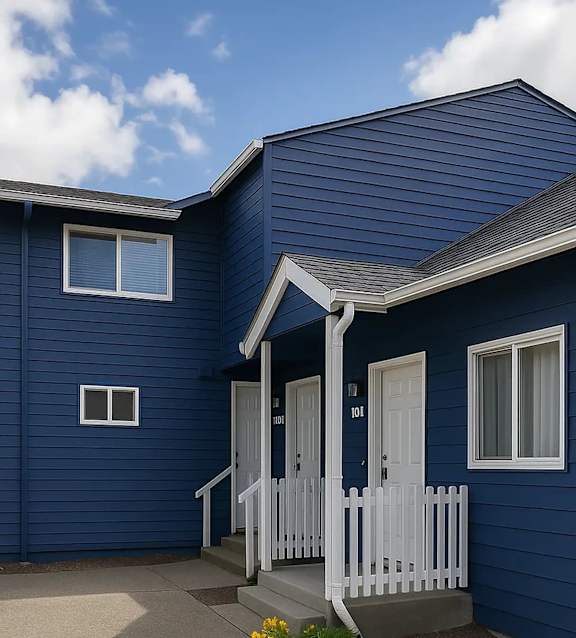 A blue house with a white door and a small porch.