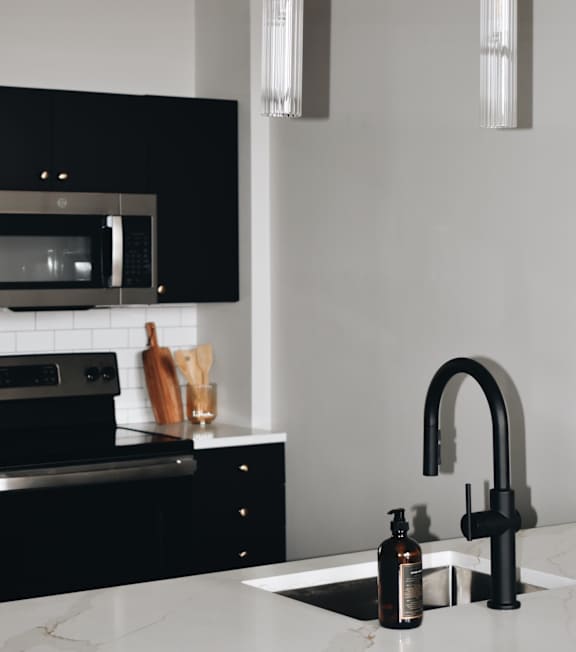 a kitchen with stainless steel appliances and wooden cabinets