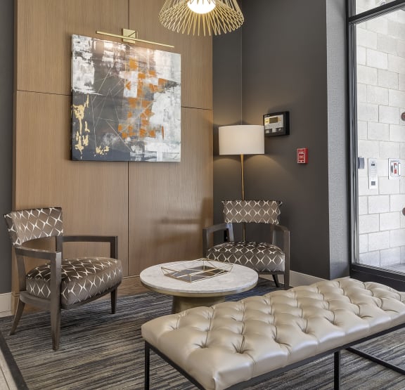 a lobby with a table and chairs and a chandelier  at Nineteen North, Buffalo, NY 14202