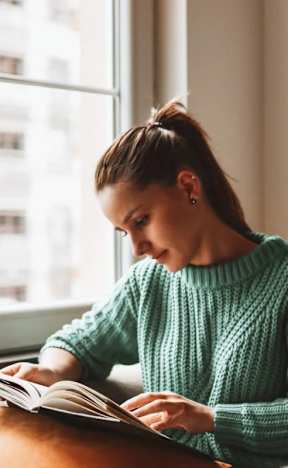 Woman is reading a book at Dash Apartments, Las Vegas