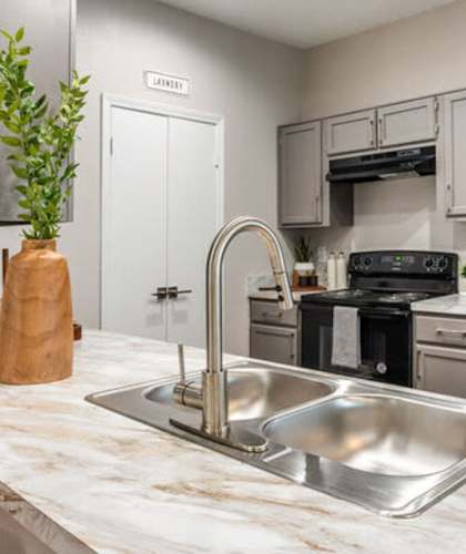 a kitchen with stainless steel appliances and a sink at Westover on 80, Mesquite, Texas