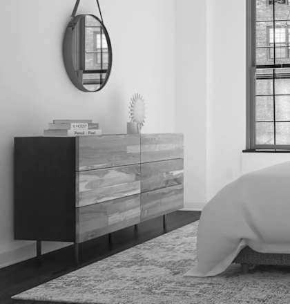 A bedroom with a bed, nightstand, and a large window.at London Terrace Gardens, New York, 10011