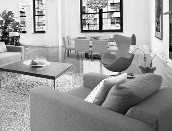A black and white photo of a living room with a couch, chairs, and a coffee table.at London Terrace Gardens, New York, 10011