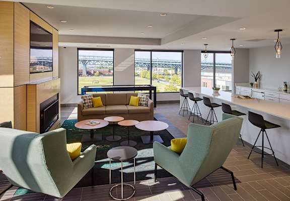 A modern living room with a view of a bridge outside the window at 11 Cooper Apartments, Camden,New Jersey, 08102