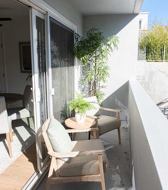 a patio with chairs and a table in a courtyard