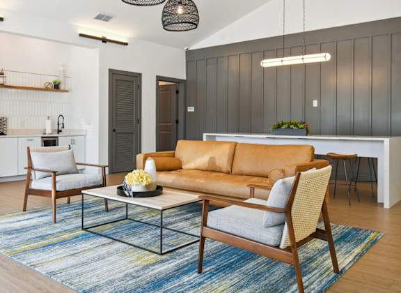 a living room with a couch and chairs and a table
