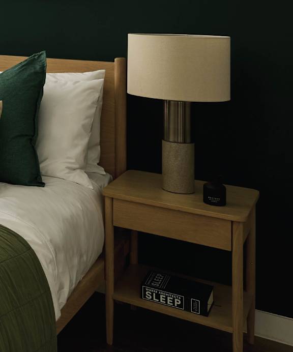 a desk with a lamp and a chair in a room