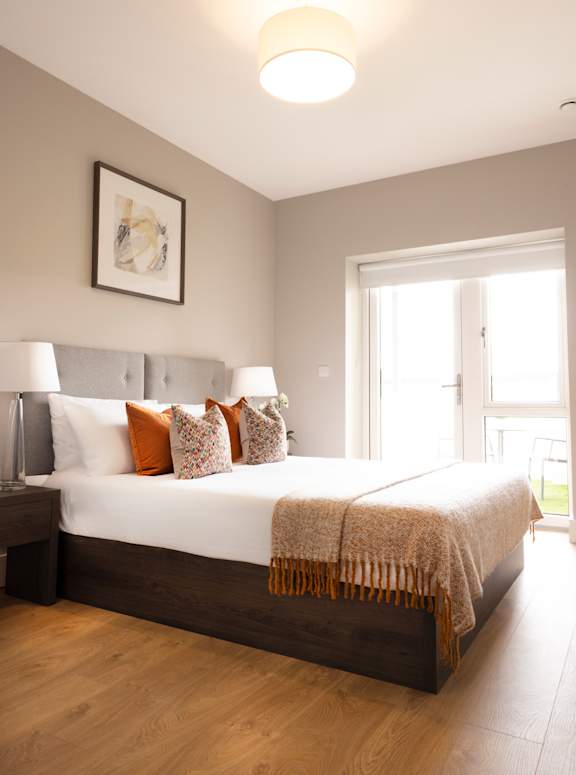 a bedroom with a large bed and a window
