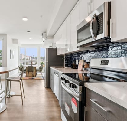 A modern kitchen with a dining table and chairs.