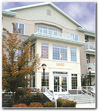 A two story building with a balcony on the second floor.