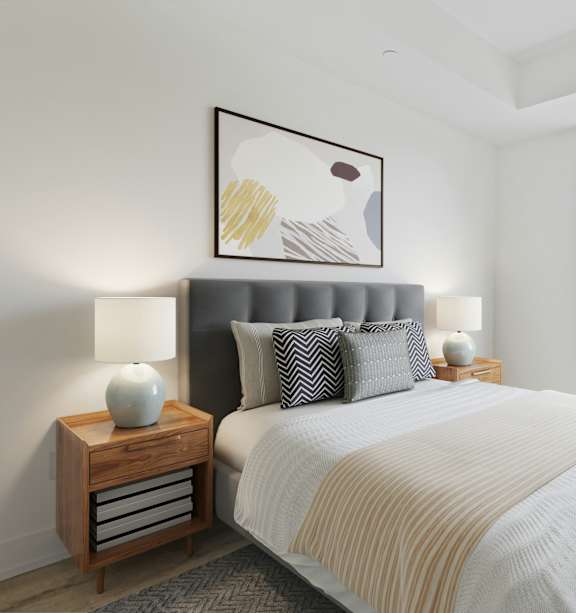 A bedroom with a large bed and a painting on the wall.