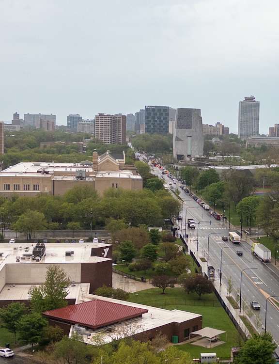 A city street with cars and buildings in the background.