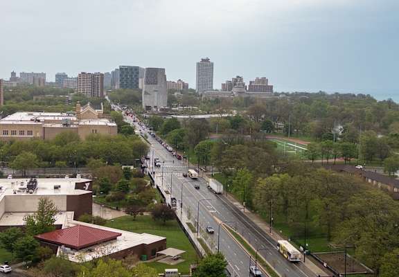 A city street with cars and buildings in the background.