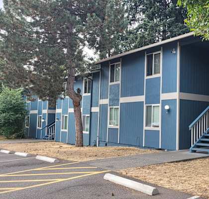 A blue building with a white door and windows.