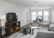 Thumbnail 1 of 5 - an apartment living room with a couch and a tv