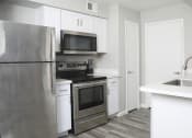 Thumbnail 5 of 5 - a kitchen with stainless steel appliances and white cabinets