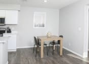 Thumbnail 3 of 5 - a kitchen and dining room with a table and chairs