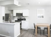 Thumbnail 2 of 5 - a kitchen and dining room with a table and chairs