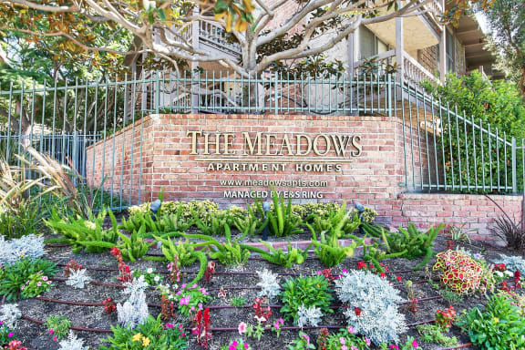 a brick wall with a sign in front of a house